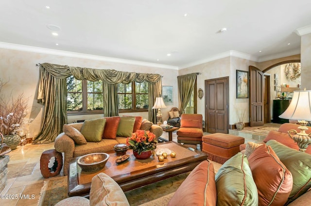 living room featuring arched walkways, ornamental molding, stone tile flooring, and recessed lighting