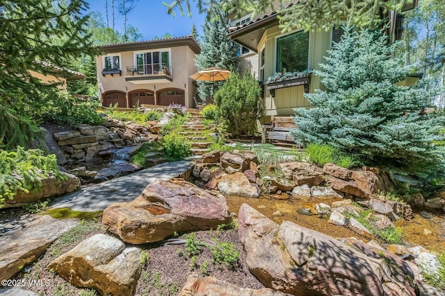 view of yard with stairway and an attached garage