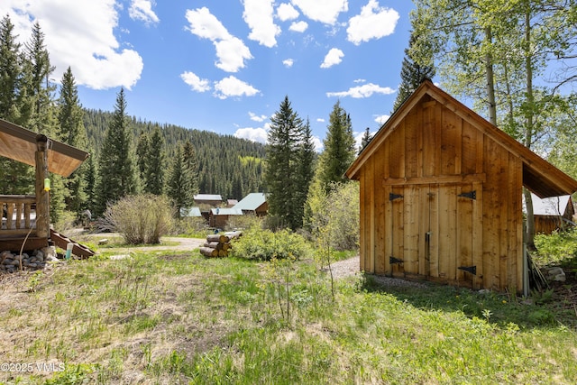 320 Mill, Eagle, CO 81631 - view of yard with a wooded view and a shed