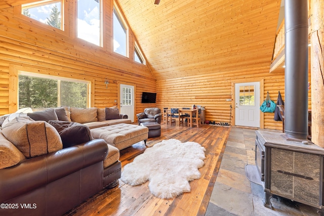 320 Mill, Eagle, CO 81631 - living room featuring high vaulted ceiling, a wood stove, rustic walls, and wood ceiling