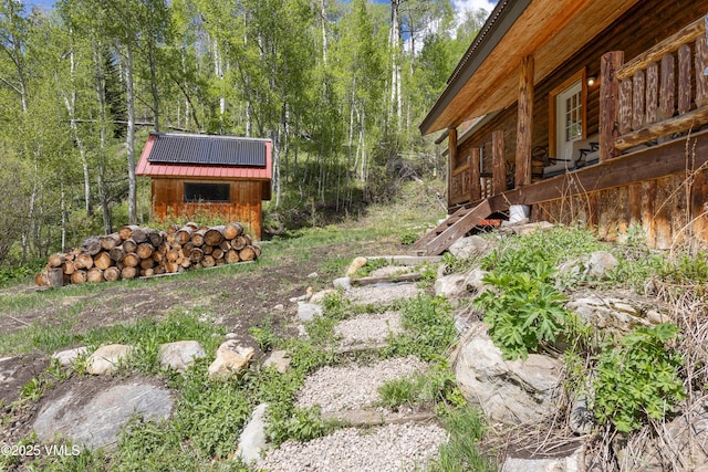 320 Mill, Eagle, CO 81631 - view of yard with an outdoor structure and a view of trees