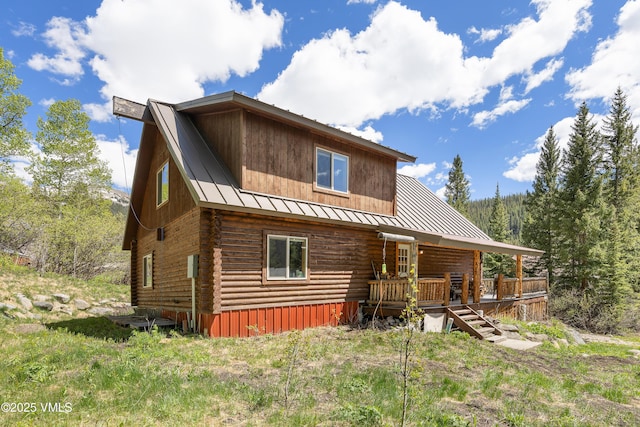 320 Mill, Eagle, CO 81631 - rear view of house featuring a standing seam roof, a metal roof, log siding, and a deck