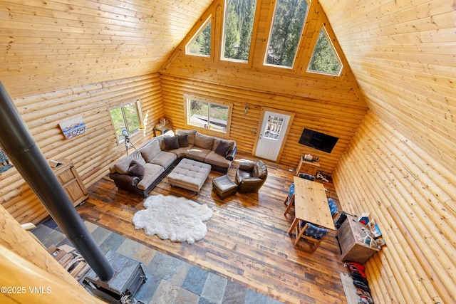 320 Mill, Eagle, CO 81631 - living room with high vaulted ceiling, log walls, a wood stove, and wood ceiling