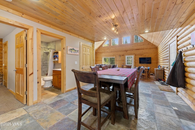 320 Mill, Eagle, CO 81631 - dining room featuring rustic walls, wooden ceiling, stone tile flooring, and vaulted ceiling