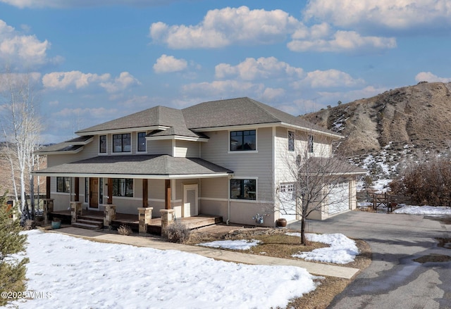 view of front of home featuring a porch and a mountain view