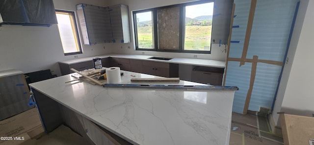 213 Harvester Ct, Eagle, CO 81631 - kitchen with light stone counters, a center island, and modern cabinets