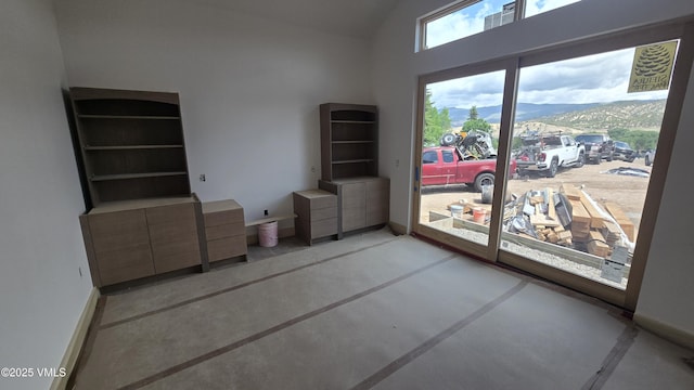 213 Harvester Ct, Eagle, CO 81631 - empty room with a mountain view, lofted ceiling, and concrete floors