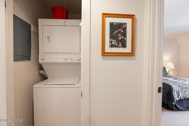 washroom with stacked washer and dryer