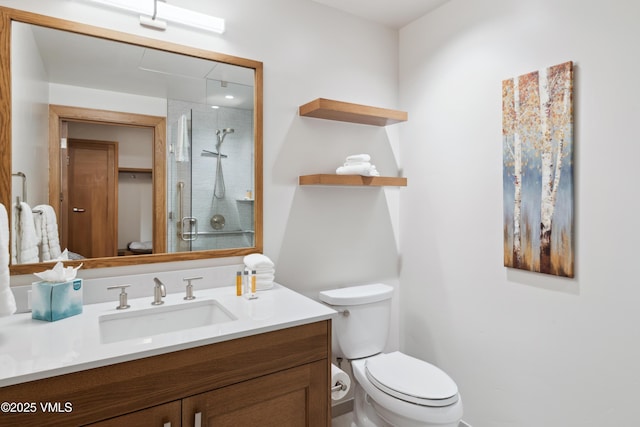 bathroom featuring vanity, toilet, and walk in shower