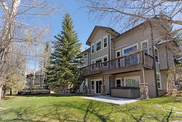 85 Remington Trl, Edwards, CO 81632 - rear view of house with a hot tub, a deck, a yard, and a patio
