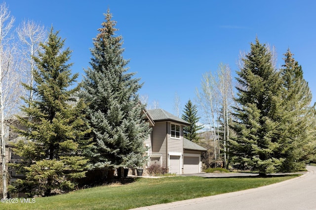 85 Remington Trl, Edwards, CO 81632 - view of property exterior with a garage, concrete driveway, and a lawn
