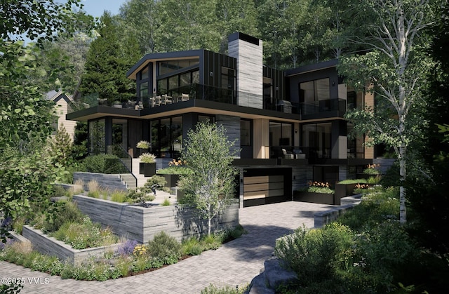 1150 Ptarmigan Rd, Vail, CO 81657 - back of property featuring an attached garage, decorative driveway, and a balcony