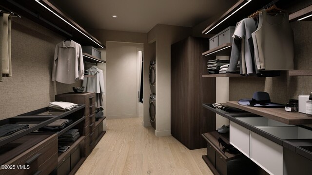1150 Ptarmigan Rd, Vail, CO 81657 - walk in closet with stacked washing machine and dryer and light wood-type flooring
