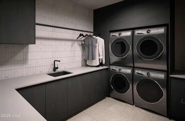 1150 Ptarmigan Rd, Vail, CO 81657 - washroom featuring stacked washer / dryer, washer and clothes dryer, cabinet space, and light tile patterned floors