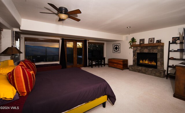 bedroom with a fireplace and carpet