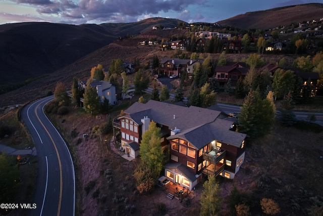 aerial view at dusk featuring a mountain view