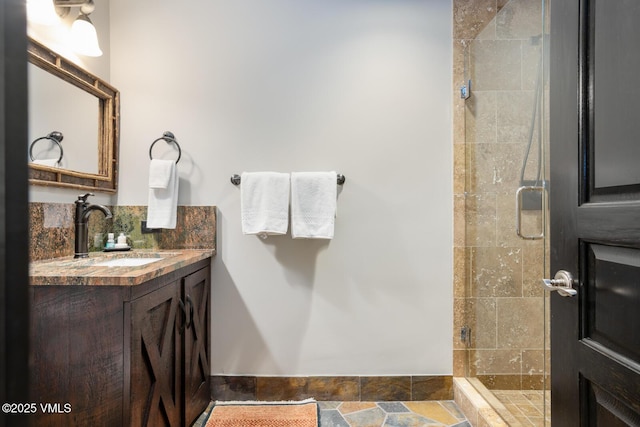 bathroom featuring a stall shower, tasteful backsplash, and vanity