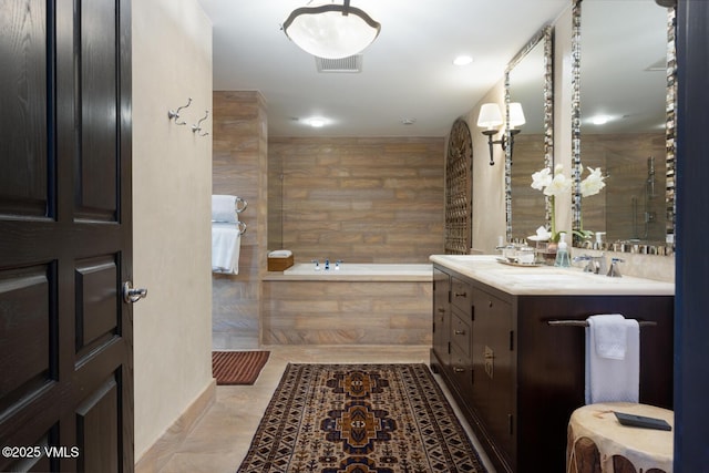 full bath with visible vents, a garden tub, tile patterned flooring, walk in shower, and vanity