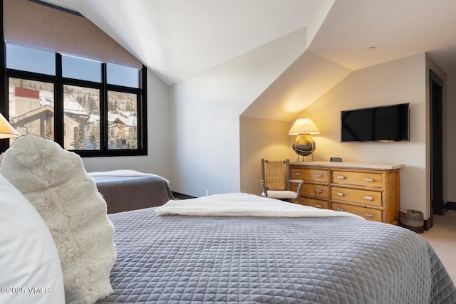 carpeted bedroom featuring vaulted ceiling