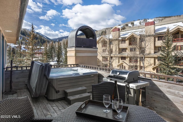 exterior space with a mountain view and a hot tub