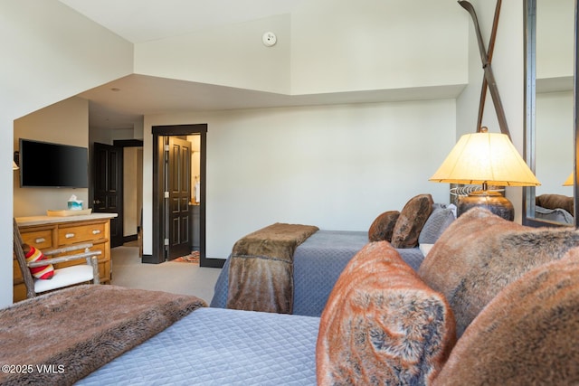 bedroom with high vaulted ceiling and carpet