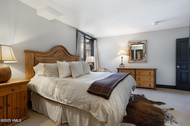 bedroom featuring light carpet and baseboards