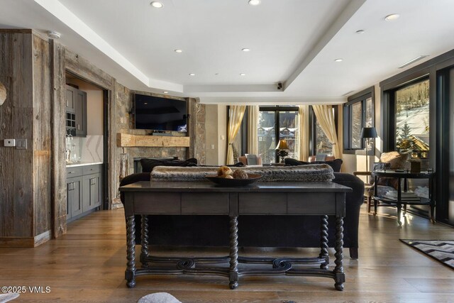 bedroom featuring recessed lighting, a fireplace, and dark wood finished floors