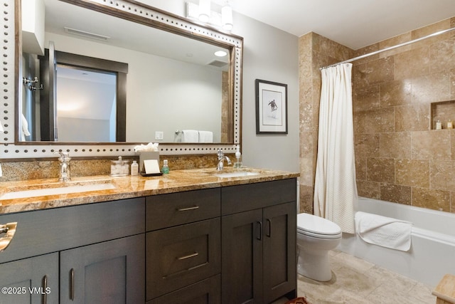 full bathroom featuring double vanity, a sink, toilet, and shower / bath combo with shower curtain