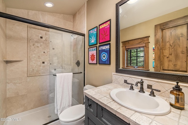 922 June Creek Rd, Edwards, CO 81632 - bathroom featuring toilet, vanity, tasteful backsplash, a stall shower, and recessed lighting