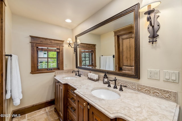 922 June Creek Rd, Edwards, CO 81632 - bathroom featuring double vanity, baseboards, and recessed lighting