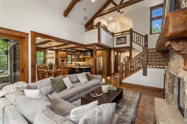 922 June Creek Rd, Edwards, CO 81632 - living area with high vaulted ceiling, beamed ceiling, hardwood / wood-style floors, stairway, and a chandelier
