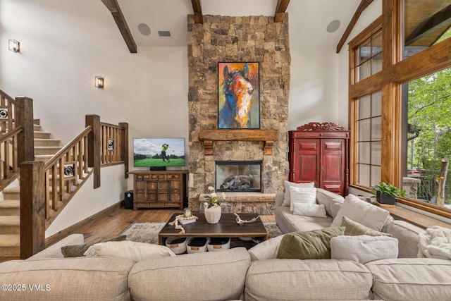 922 June Creek Rd, Edwards, CO 81632 - living area with beamed ceiling, wood finished floors, stairway, high vaulted ceiling, and a fireplace