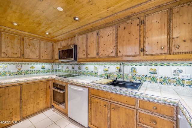 600 Vail Valley Dr Unit 310, Vail, CO 81657 - kitchen with appliances with stainless steel finishes, tile countertops, brown cabinetry, wood ceiling, and light tile patterned floors