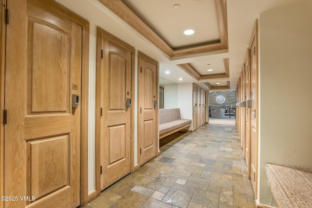 600 Vail Valley Dr Unit 310, Vail, CO 81657 - hall featuring stone tile flooring, a raised ceiling, and stairway
