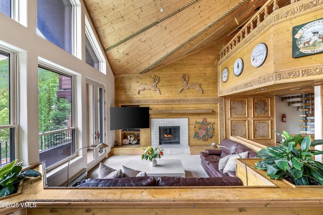 600 Vail Valley Dr Unit 310, Vail, CO 81657 - living area with high vaulted ceiling, wooden walls, a lit fireplace, and wood ceiling