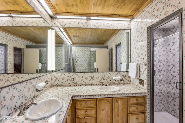 600 Vail Valley Dr Unit 310, Vail, CO 81657 - full bathroom featuring ornamental molding, wallpapered walls, double vanity, a shower stall, and wooden ceiling