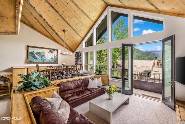 600 Vail Valley Dr Unit 310, Vail, CO 81657 - living room featuring high vaulted ceiling, a wooden ceiling with exposed beams, healthy amount of natural light, and a chandelier