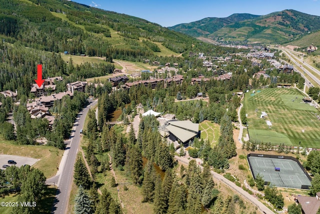 600 Vail Valley Dr Unit 310, Vail, CO 81657 - aerial view of property and surrounding area with a mountainous background and a forest