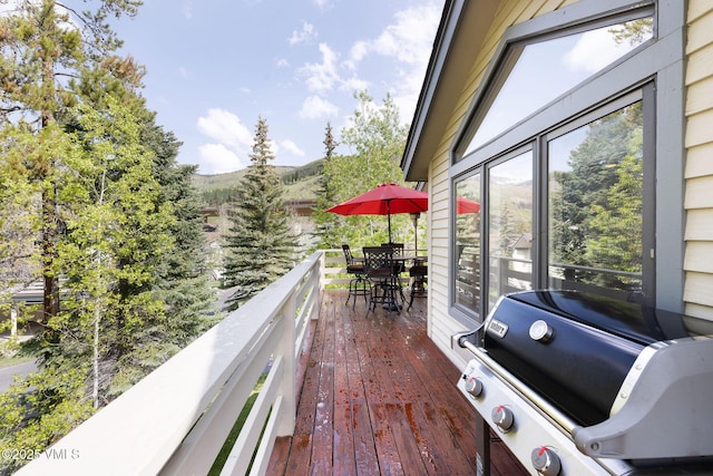4515 Bighorn Rd, Vail, CO 81657 - wooden terrace featuring a grill, outdoor dining space, and a mountain view