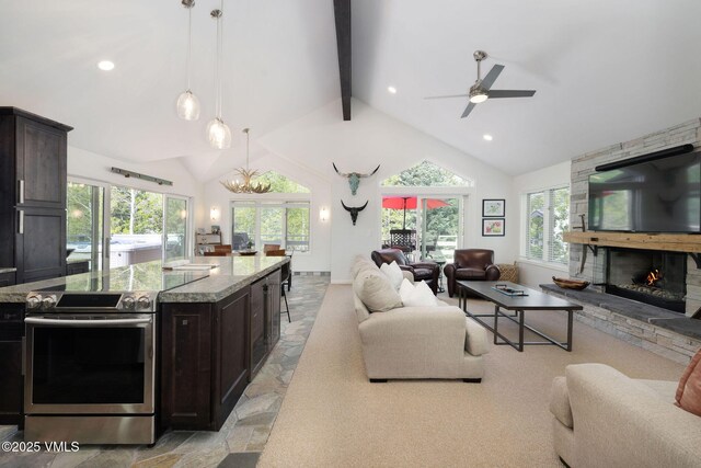 4515 Bighorn Rd, Vail, CO 81657 - living area with stone tile floors, a stone fireplace, beam ceiling, ceiling fan, and recessed lighting