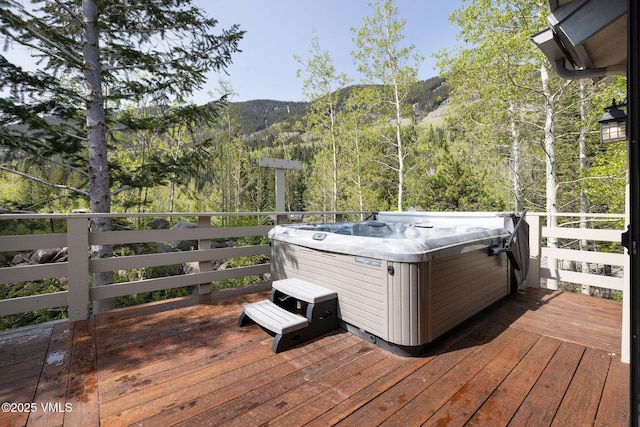 4515 Bighorn Rd, Vail, CO 81657 - wooden deck featuring a hot tub, a forest view, and a mountain view