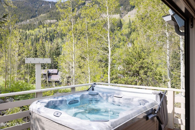 4515 Bighorn Rd, Vail, CO 81657 - wooden deck with a wooded view and a hot tub