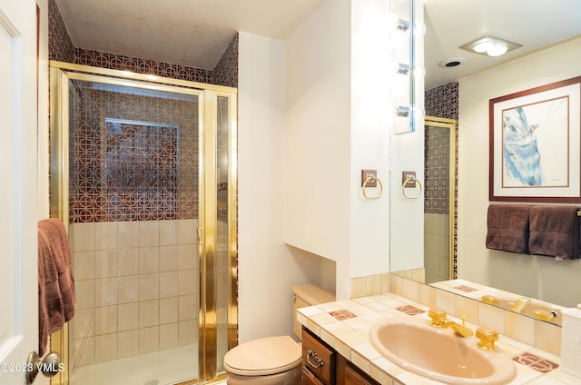 bathroom with vanity, toilet, and an enclosed shower