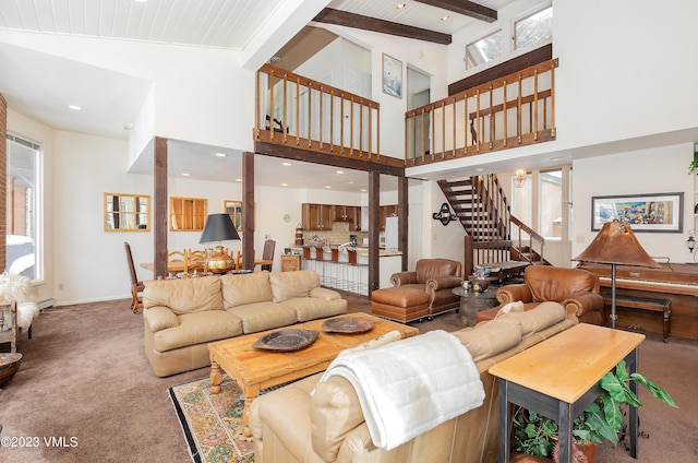 carpeted living room with beam ceiling, high vaulted ceiling, and a wealth of natural light