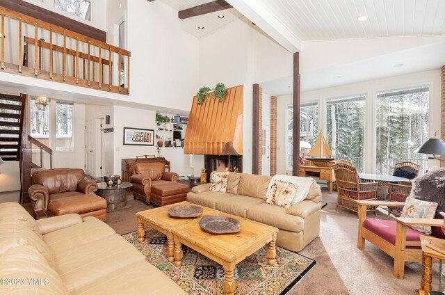 living room with high vaulted ceiling and light carpet