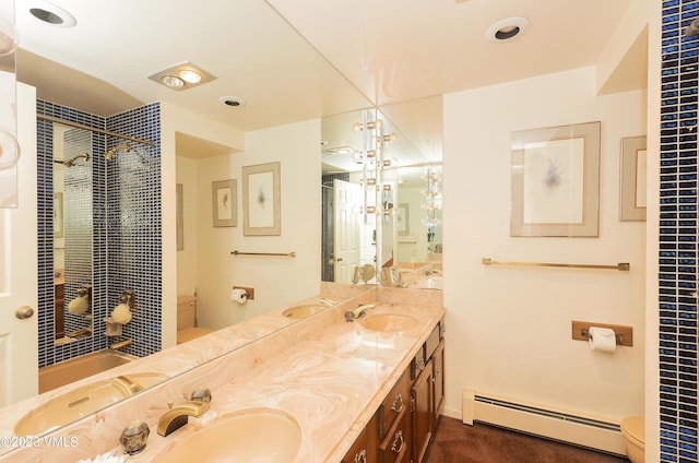 bathroom with vanity, toilet, a shower with shower curtain, and a baseboard heating unit