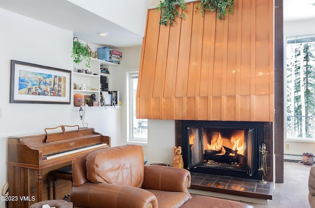 sitting room with carpet floors, a fireplace, and a baseboard radiator