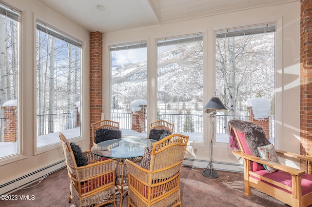 sunroom / solarium featuring baseboard heating