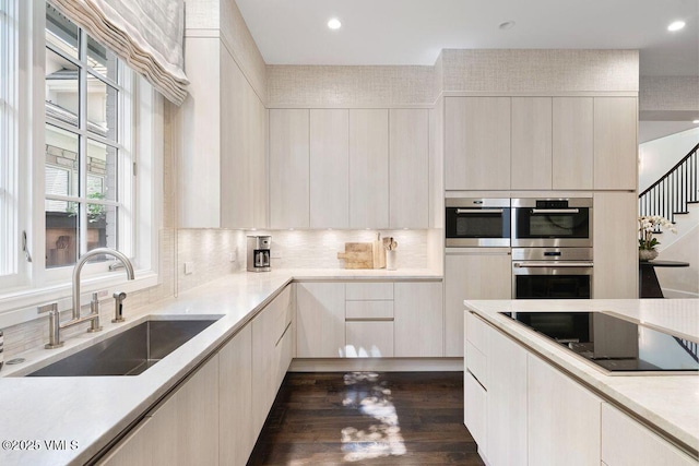 450 Steele St, Denver, CO 80236 - kitchen featuring black electric stovetop, light countertops, double oven, modern cabinets, and dark wood-style flooring