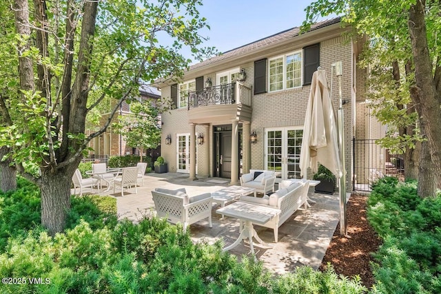 450 Steele St, Denver, CO 80236 - back of property with french doors, a balcony, a patio, brick siding, and an outdoor hangout area